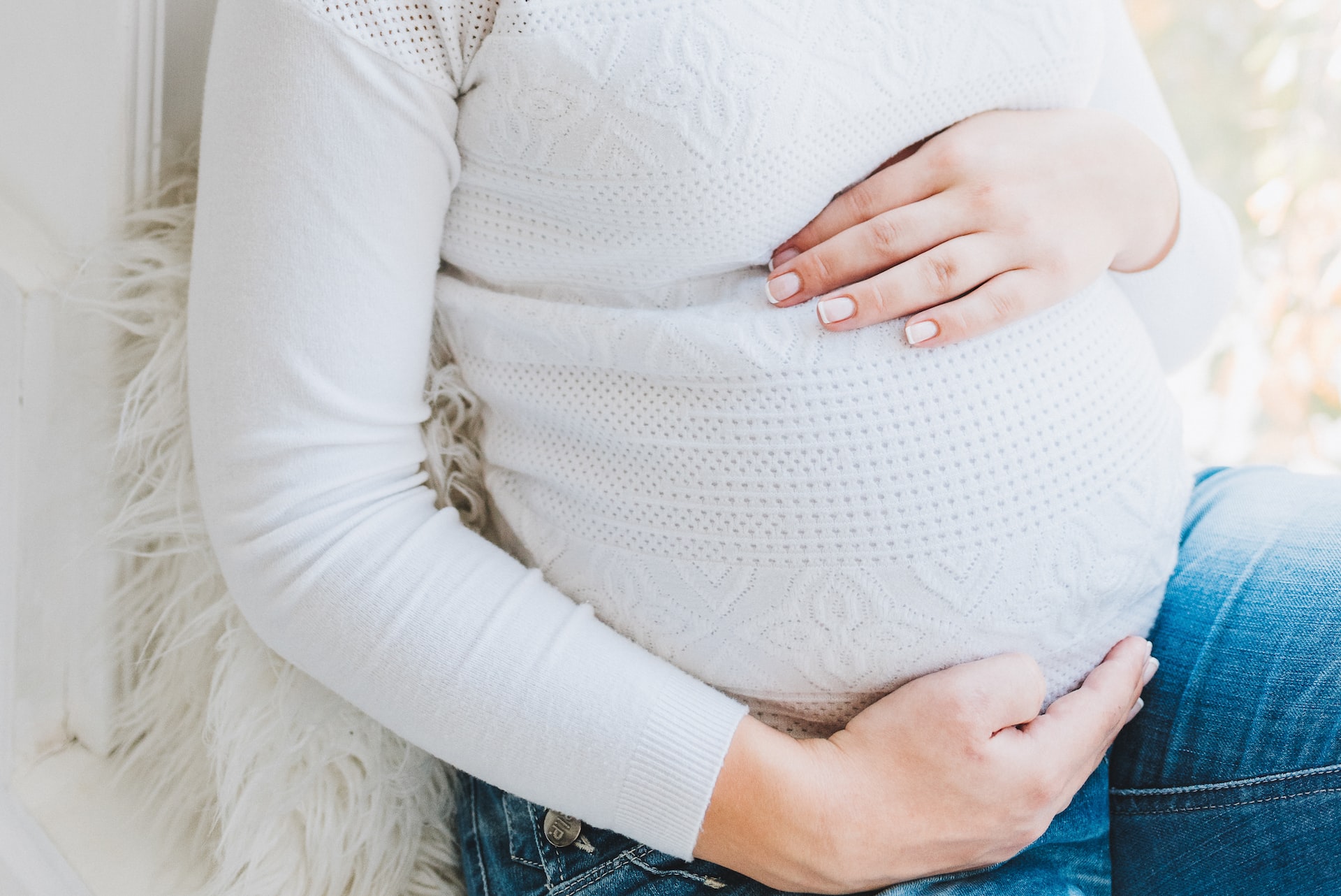 Pregant woman in white long sleeve shirt